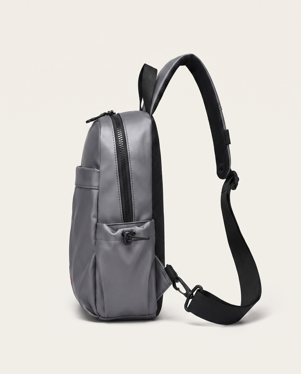 Compact sling bag holding a 9-inch tablet, phone, wallet and power bank