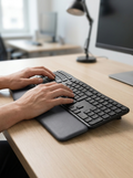 Ergonomic split wireless keyboard with cushioned integrated wrist rest