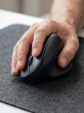 Vertical ergonomic wireless mouse holding the wrist in a natural handshake position