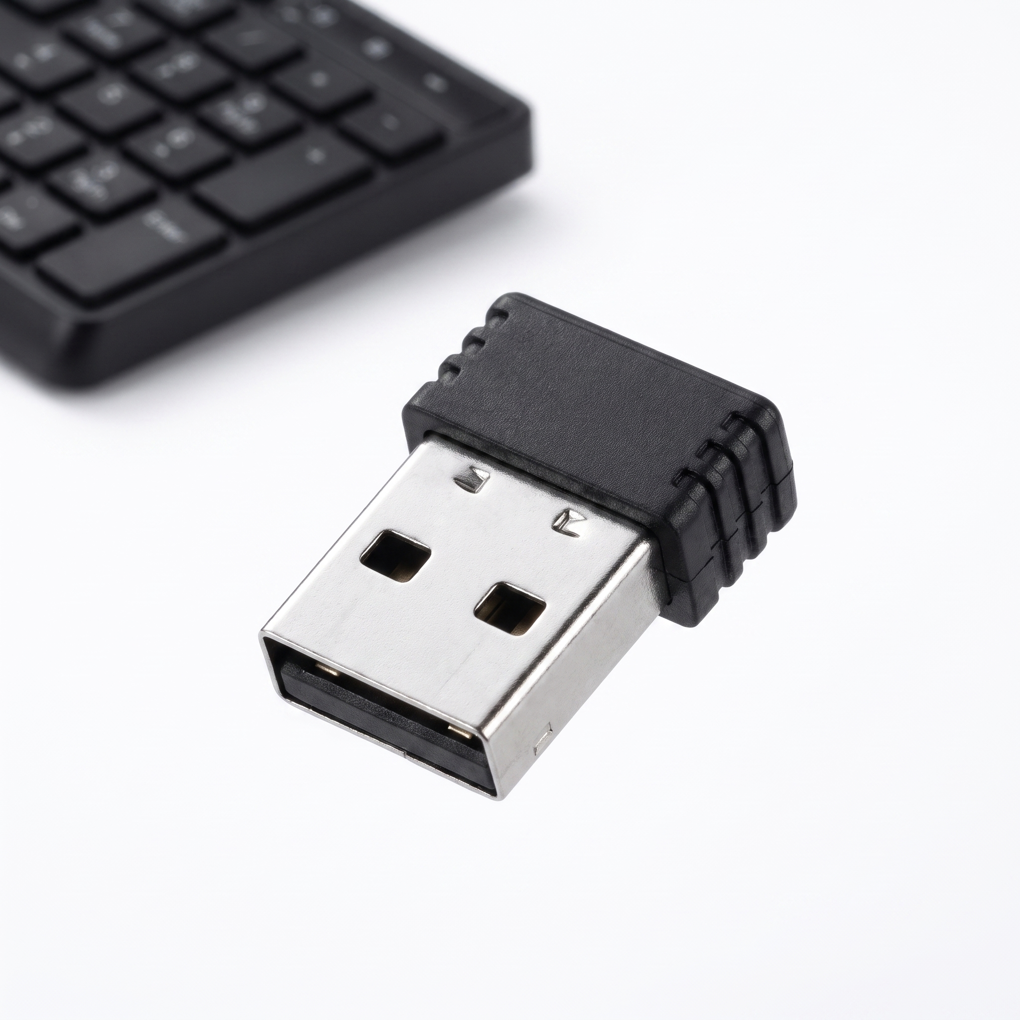 Macro close-up of the plug-and-play USB nano receiver supplied with the wireless keyboard and mouse set