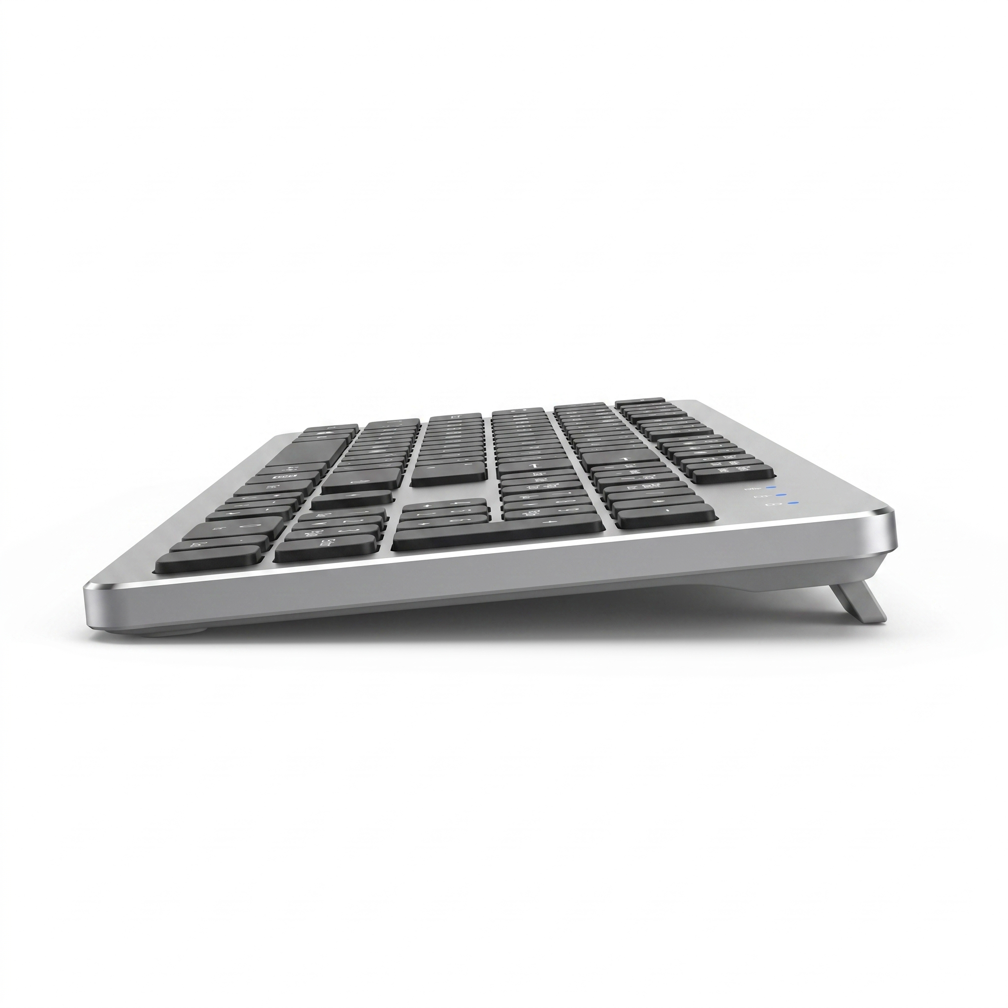 Side profile of the ultra-slim wireless keyboard showing the thin aluminium wedge and rear tilt foot